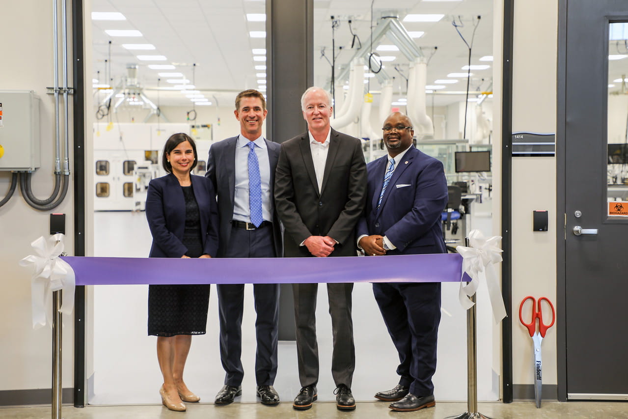 (L to R): Ana Hooker, Kevin Conroy, Rich Lynch and Dr. Ruben Anthony stand in front of ribbon in front of lab door at Nexus One grand opening event.