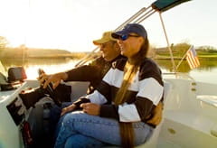 Diane S. and man driving a ski boat